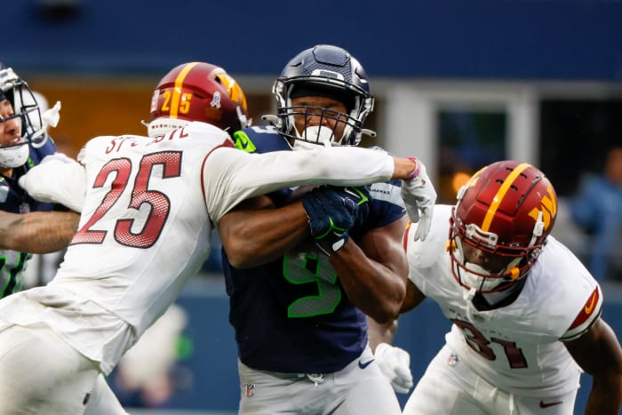 Seattle Seahawks running back Kenneth Walker III (9) rushes against the Washington Commanders during the second quarter at Lumen Field.